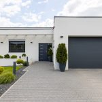 Outside view of elegant suburban house with big window green lawn